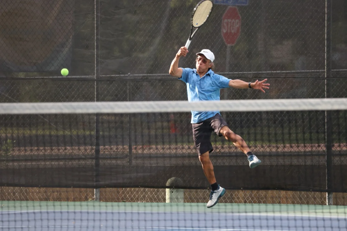 Player leaping for a forehand at Broomfield Open