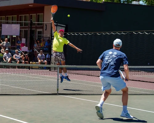 Doubles action with overhead smash at Denver City Open