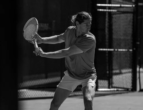 Player preparing for backhand in dramatic black and white