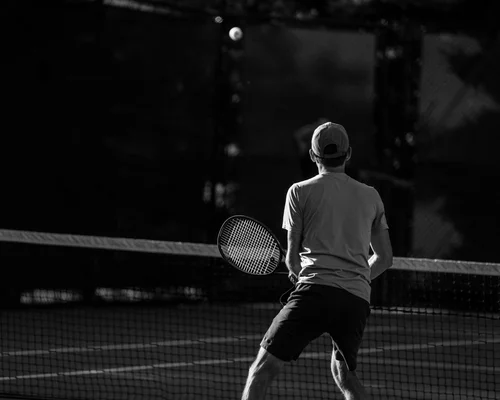 Player awaiting serve in artistic black and white