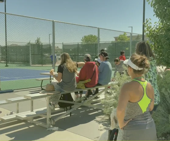 Spectators watching from bleachers at Longmont Open